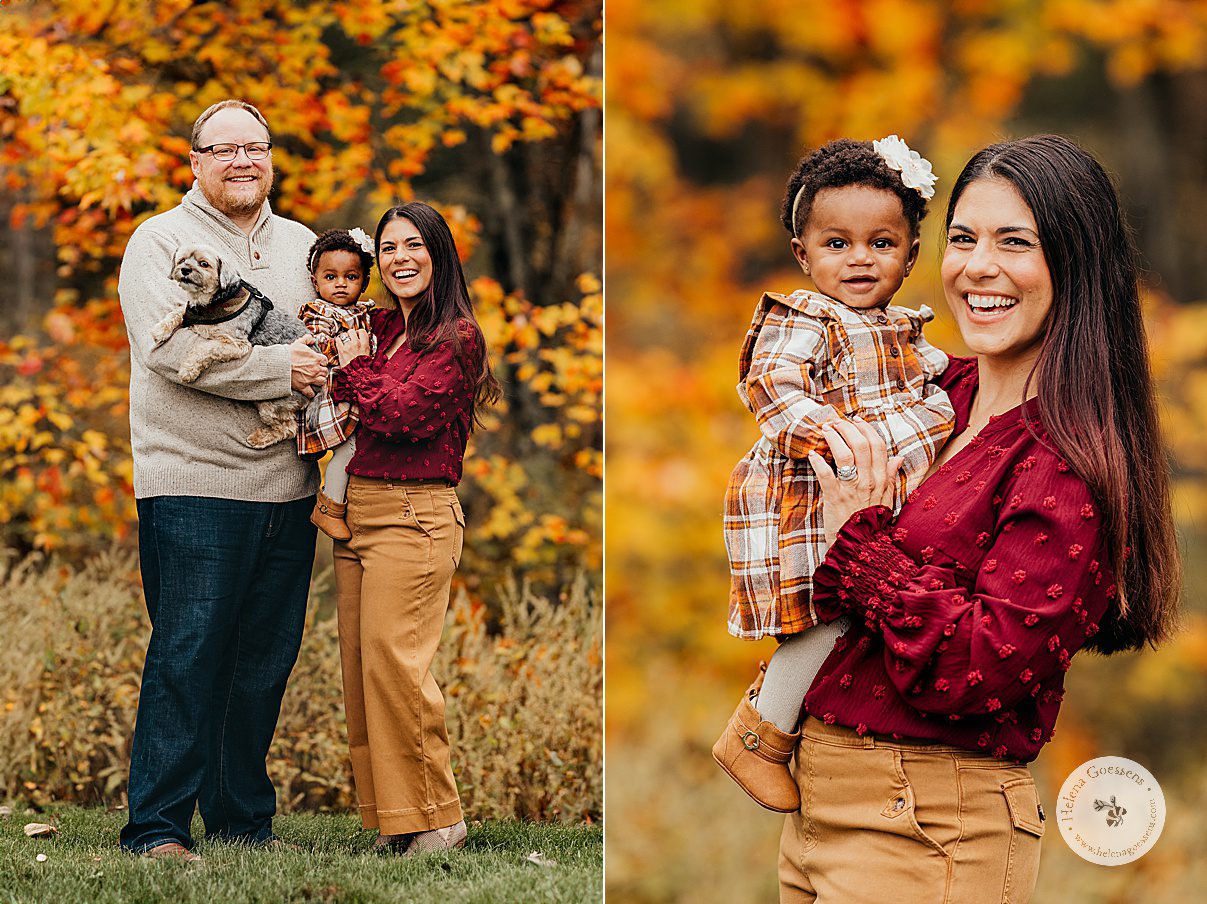 parents hold toddler on hip posing in backyard during fall lifestyle family portraits in Westwood MA