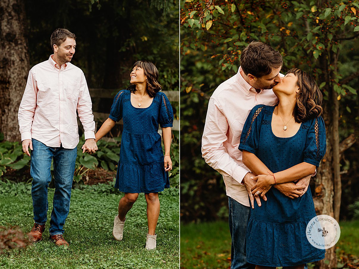 husband and wife hold hands and kiss in backyard of Dedham home during fall family photos 