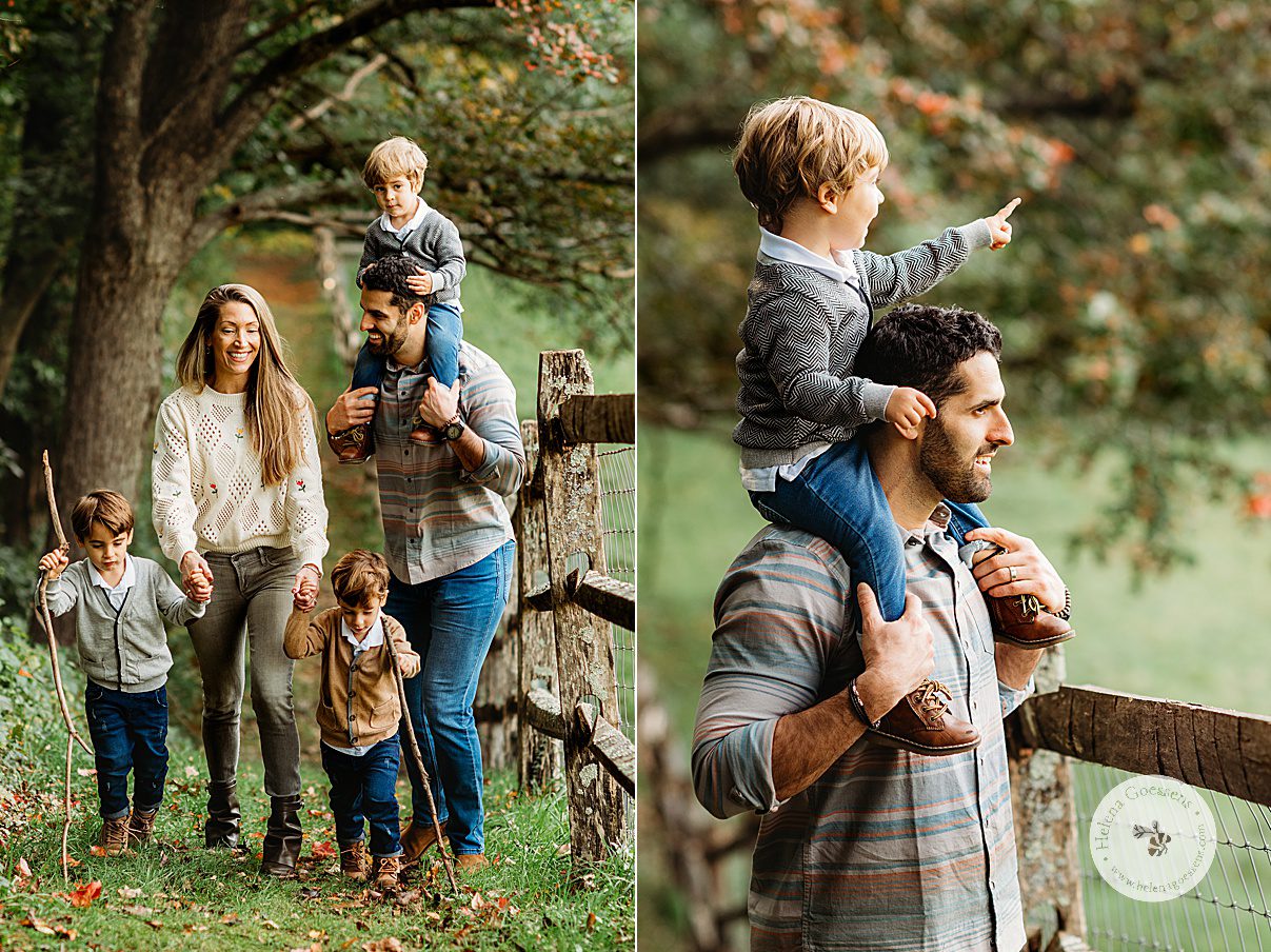 parents walk with three boys along wooden fence line during fall family portraits at the Bradley Estate
