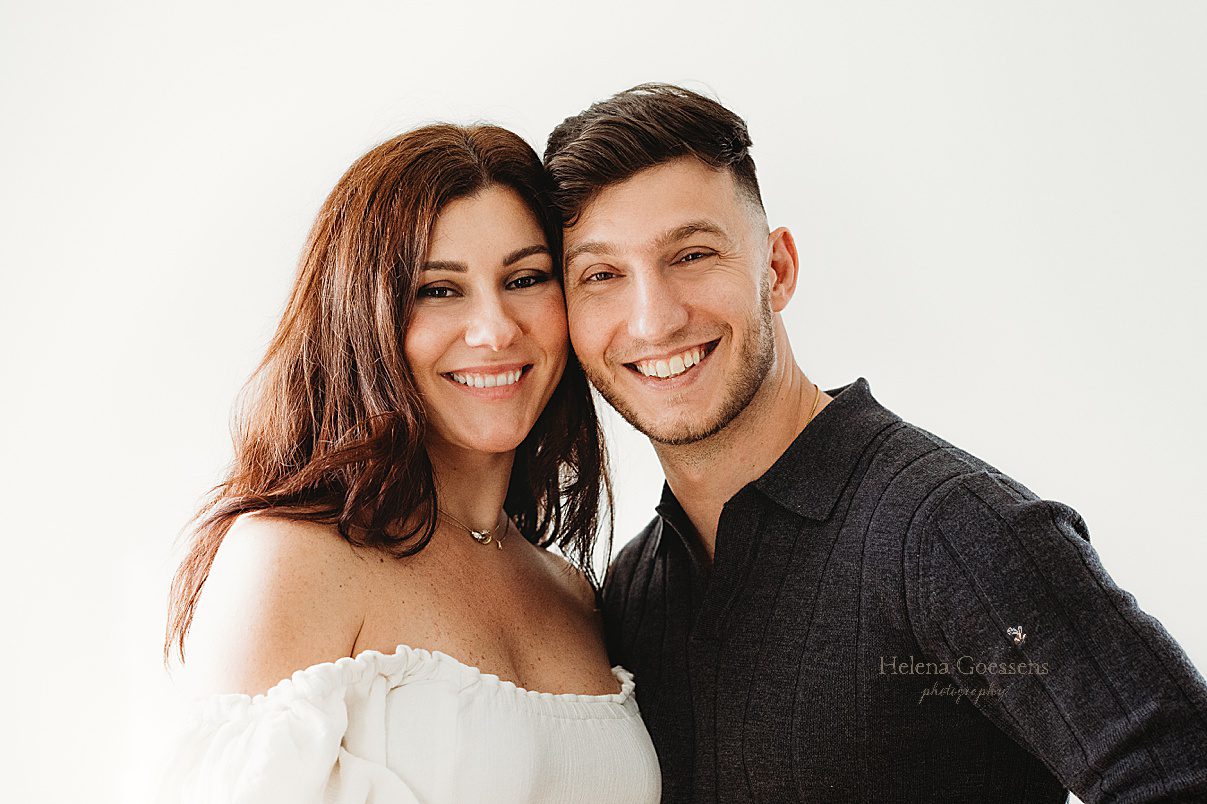 couple smiles leaning heads together during photos at home 