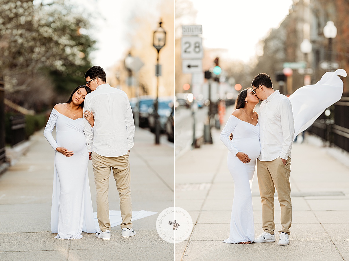 woman in white gown holds baby bump leaning on husband's arm during Boston Back Bay maternity portraits