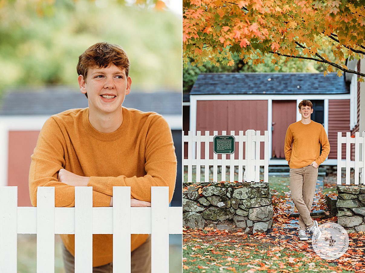 senior leans against white fence during Larz Anderson Park senior portraits